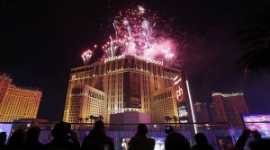 People watch from the The Cosmopolitan hotel and casino as fireworks explode during New Year's Eve celebrations in Las Vegas.